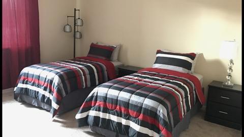 bedroom featuring light colored carpet