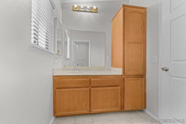 bathroom featuring tile patterned flooring and vanity