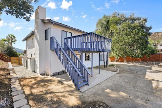 back of property with a patio and a deck