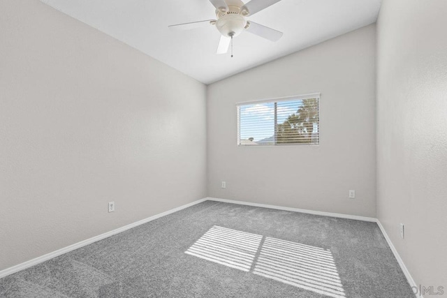 carpeted spare room with vaulted ceiling and ceiling fan