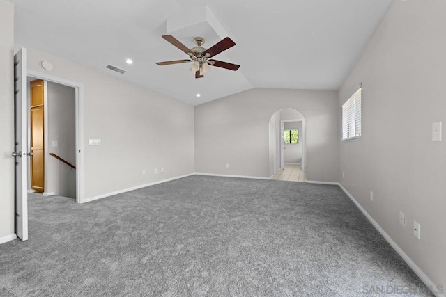 spare room featuring light carpet, ceiling fan, and lofted ceiling