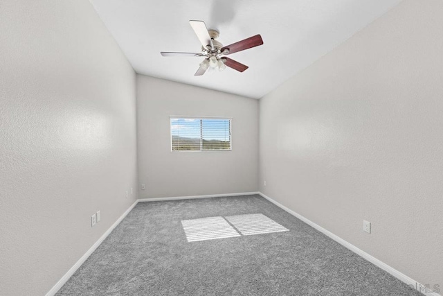 empty room featuring ceiling fan, lofted ceiling, and carpet floors