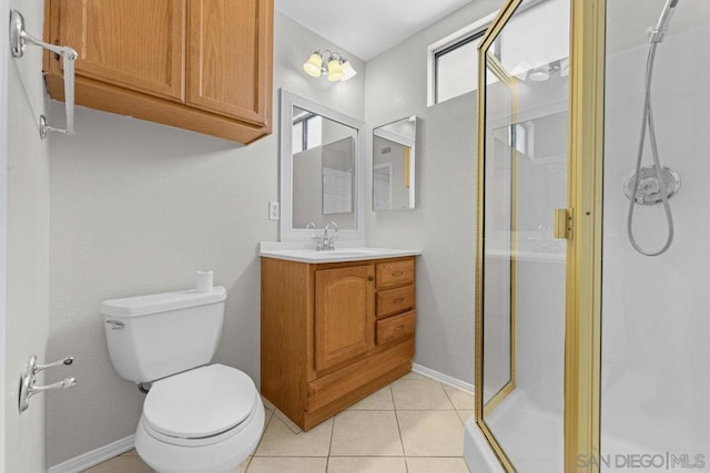 bathroom featuring toilet, vanity, tile patterned floors, and a shower with shower door