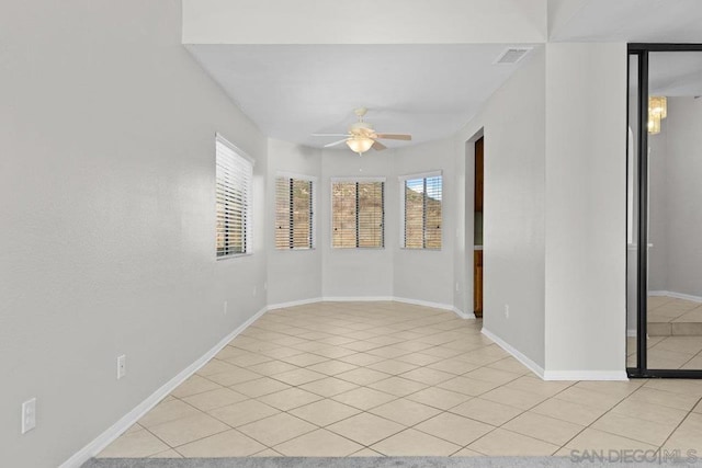 empty room featuring light tile patterned floors and ceiling fan