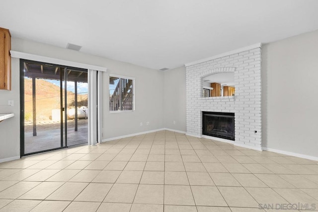 unfurnished living room with light tile patterned flooring and a fireplace