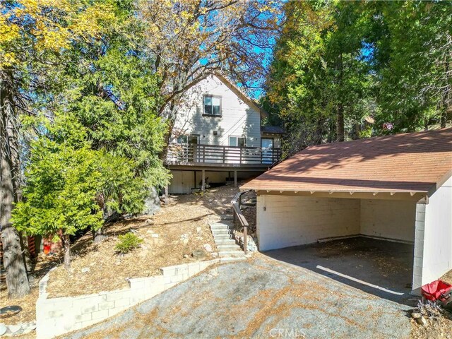 view of front of home with a deck and a carport