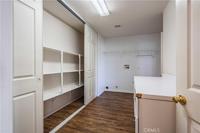 clothes washing area featuring hookup for a washing machine and dark hardwood / wood-style floors