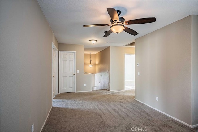 carpeted empty room featuring ceiling fan