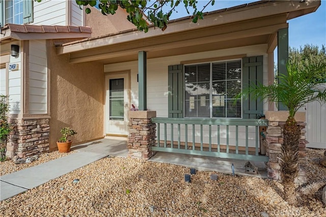 entrance to property featuring covered porch