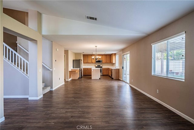 unfurnished living room featuring dark hardwood / wood-style flooring, vaulted ceiling, a chandelier, and sink