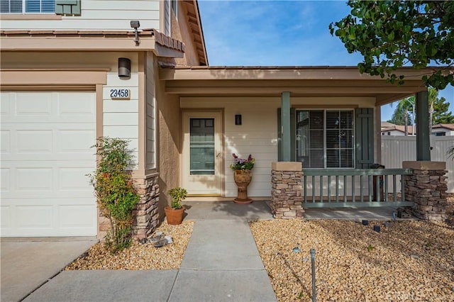 property entrance featuring a porch and a garage