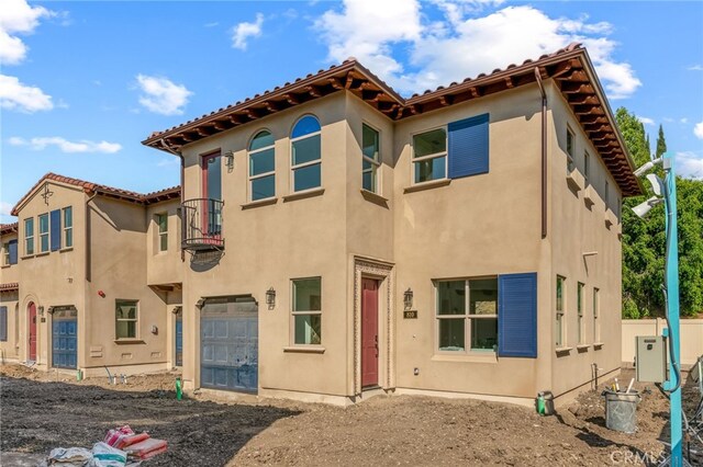 view of front of house with a garage and a balcony