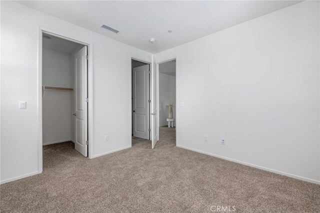 unfurnished bedroom featuring carpet and a closet