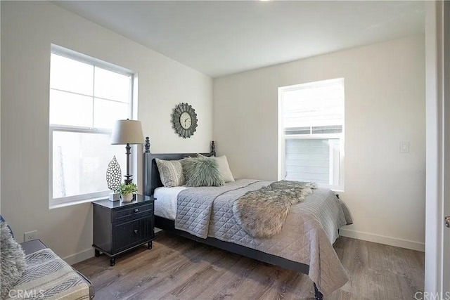 bedroom with hardwood / wood-style flooring