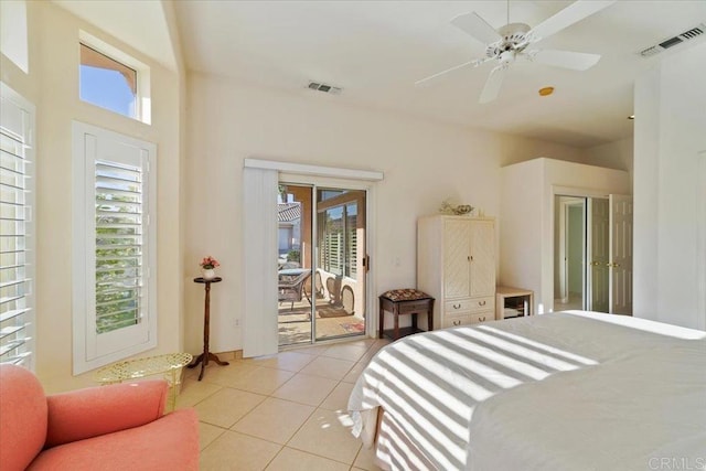 bedroom featuring access to exterior, light tile patterned floors, and ceiling fan