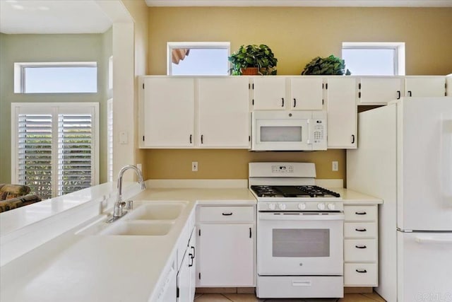 kitchen featuring white appliances, a healthy amount of sunlight, and sink