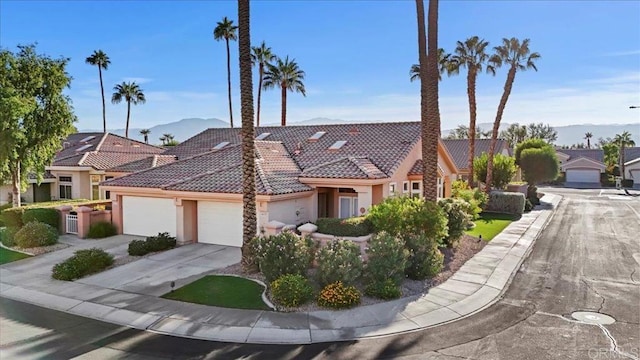 view of front of property with a mountain view and a garage