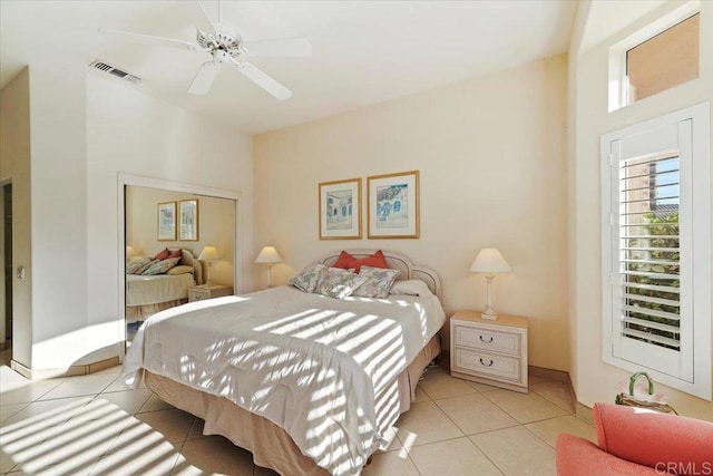 bedroom with ceiling fan and light tile patterned floors