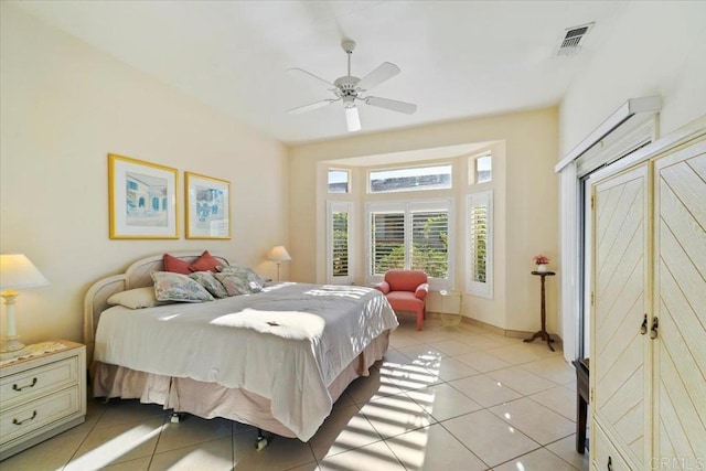 tiled bedroom with ceiling fan