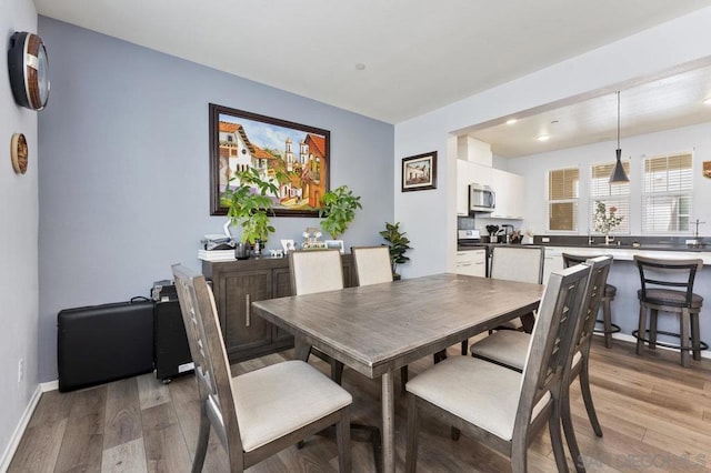 dining space featuring wood-type flooring