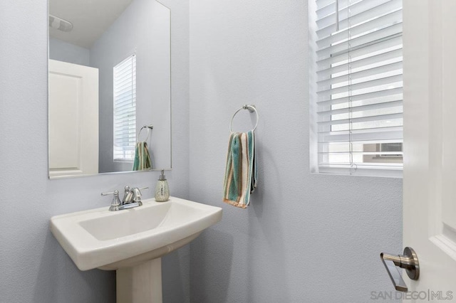 bathroom featuring a wealth of natural light and sink