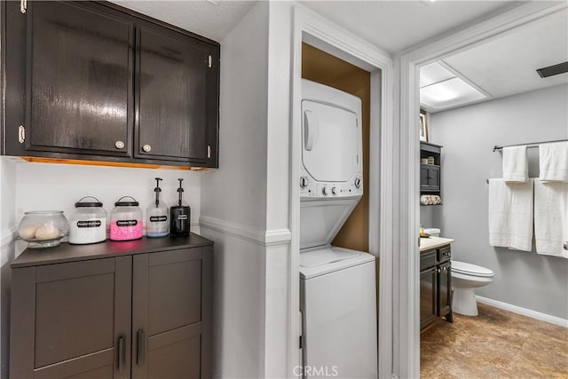 clothes washing area with stacked washer / dryer