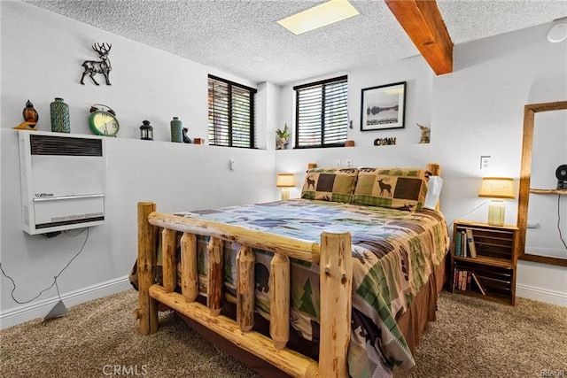 bedroom with carpet flooring, beam ceiling, a textured ceiling, and heating unit