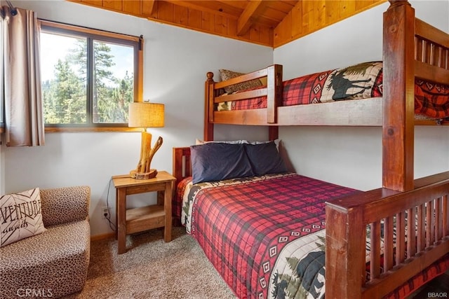 bedroom with light carpet, vaulted ceiling with beams, and wood ceiling