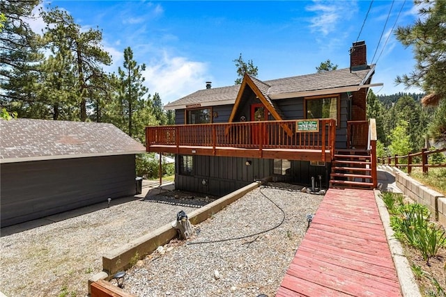 back of property featuring a wooden deck