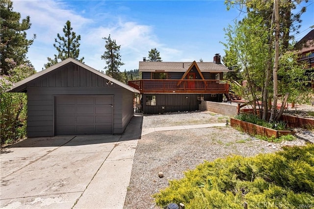 view of front of property with an outbuilding, a deck, and a garage