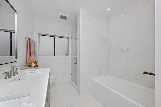 full bathroom with shower with separate bathtub, vanity, toilet, and tile walls