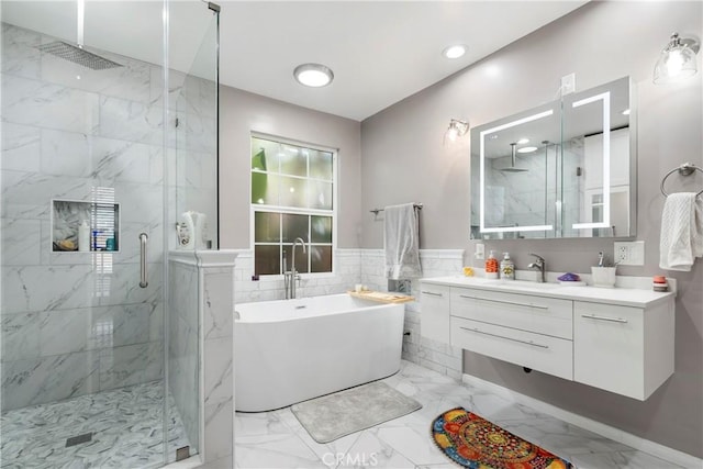 bathroom featuring vanity and shower with separate bathtub