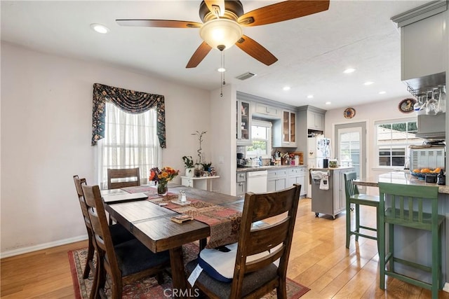 dining space featuring light wood-type flooring and ceiling fan