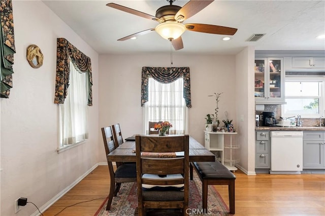 dining area featuring ceiling fan, light hardwood / wood-style flooring, and a healthy amount of sunlight