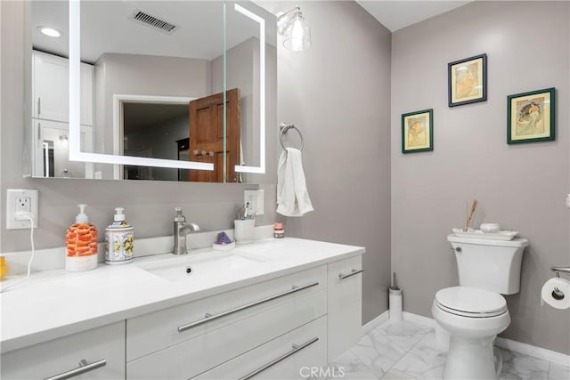 bathroom featuring vanity and toilet