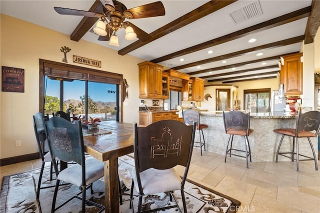 dining space featuring ceiling fan and beam ceiling