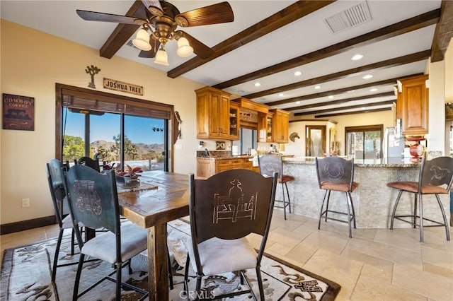 dining space with beam ceiling