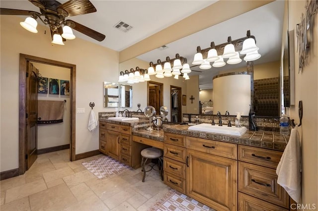 bathroom with ceiling fan and vanity