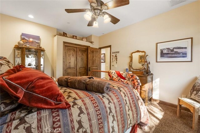 bedroom featuring ceiling fan and carpet floors