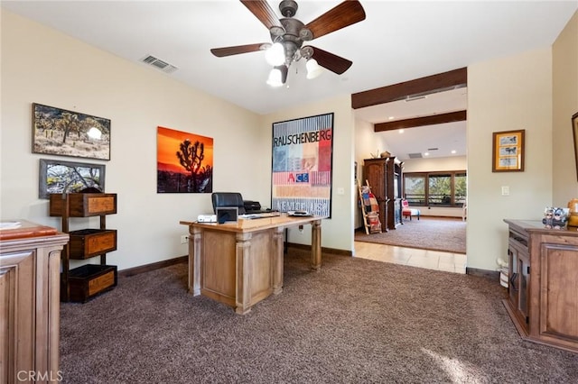 carpeted home office featuring ceiling fan and beam ceiling