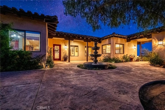 61138 Onaga Trl, Joshua Tree, CA 92252 - view of front of home featuring a tiled roof, stucco siding, and a patio area
