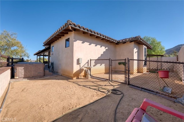 view of home's exterior featuring a hot tub and a mountain view