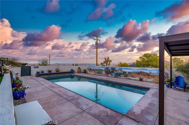 61138 Onaga Trl, Joshua Tree, CA 92252 - pool at dusk featuring a patio and a fenced backyard