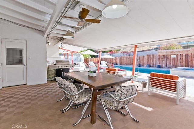 view of patio with a fenced in pool and area for grilling