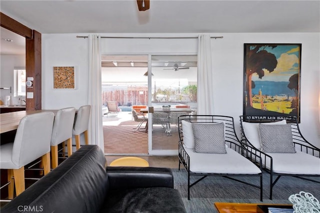 carpeted living room with ceiling fan