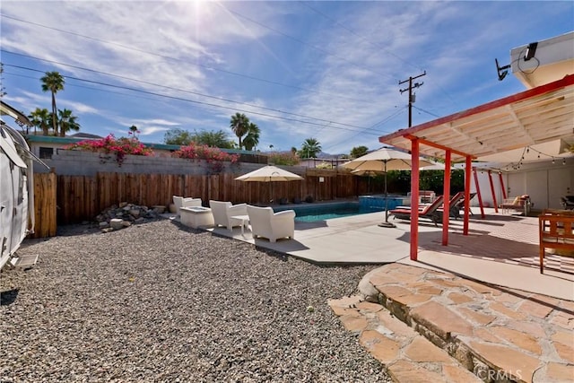 exterior space featuring a fenced in pool and a patio