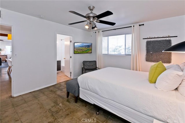 bedroom featuring ensuite bathroom and ceiling fan