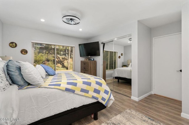 bedroom featuring a closet and light wood-type flooring