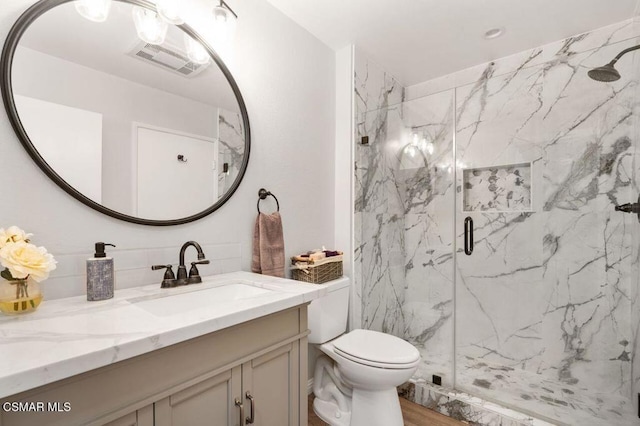 bathroom with vanity and a shower with shower door