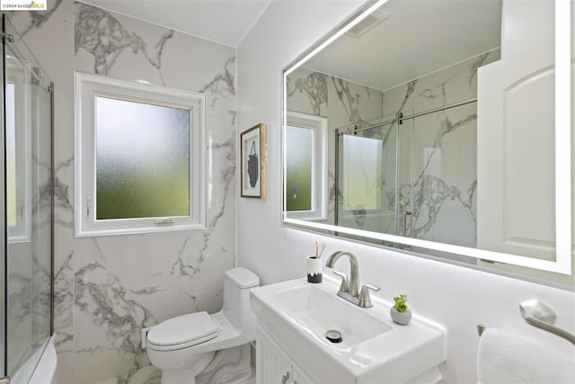 bathroom with toilet, an enclosed shower, tile walls, and vanity